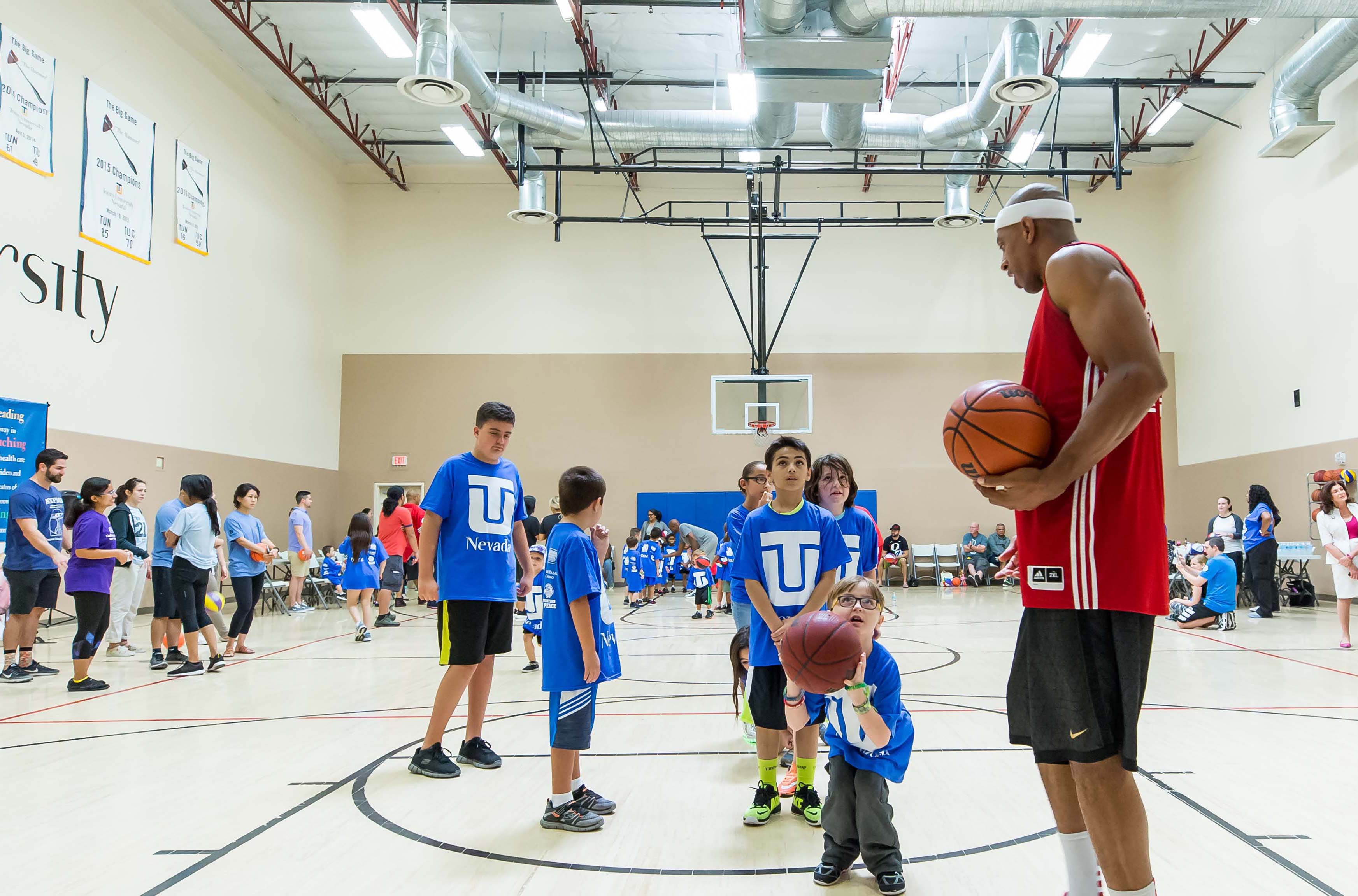 Jerome \'Junkyard Dog\' Williams coaching kids on the basketball court. 