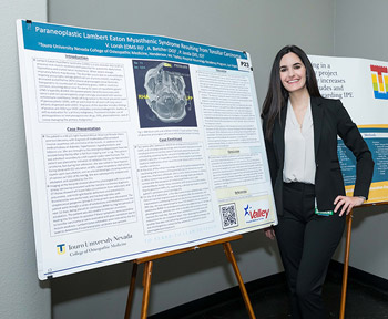 DO student with her research project board on Research Day