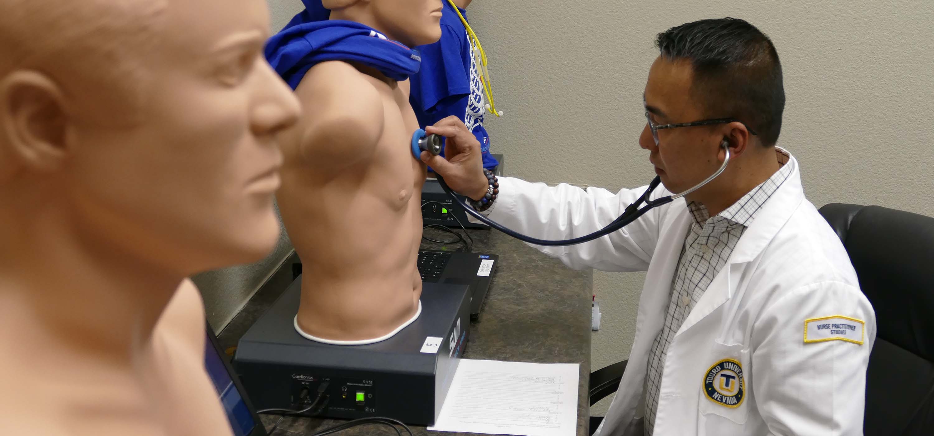 A student practices on a manikin.