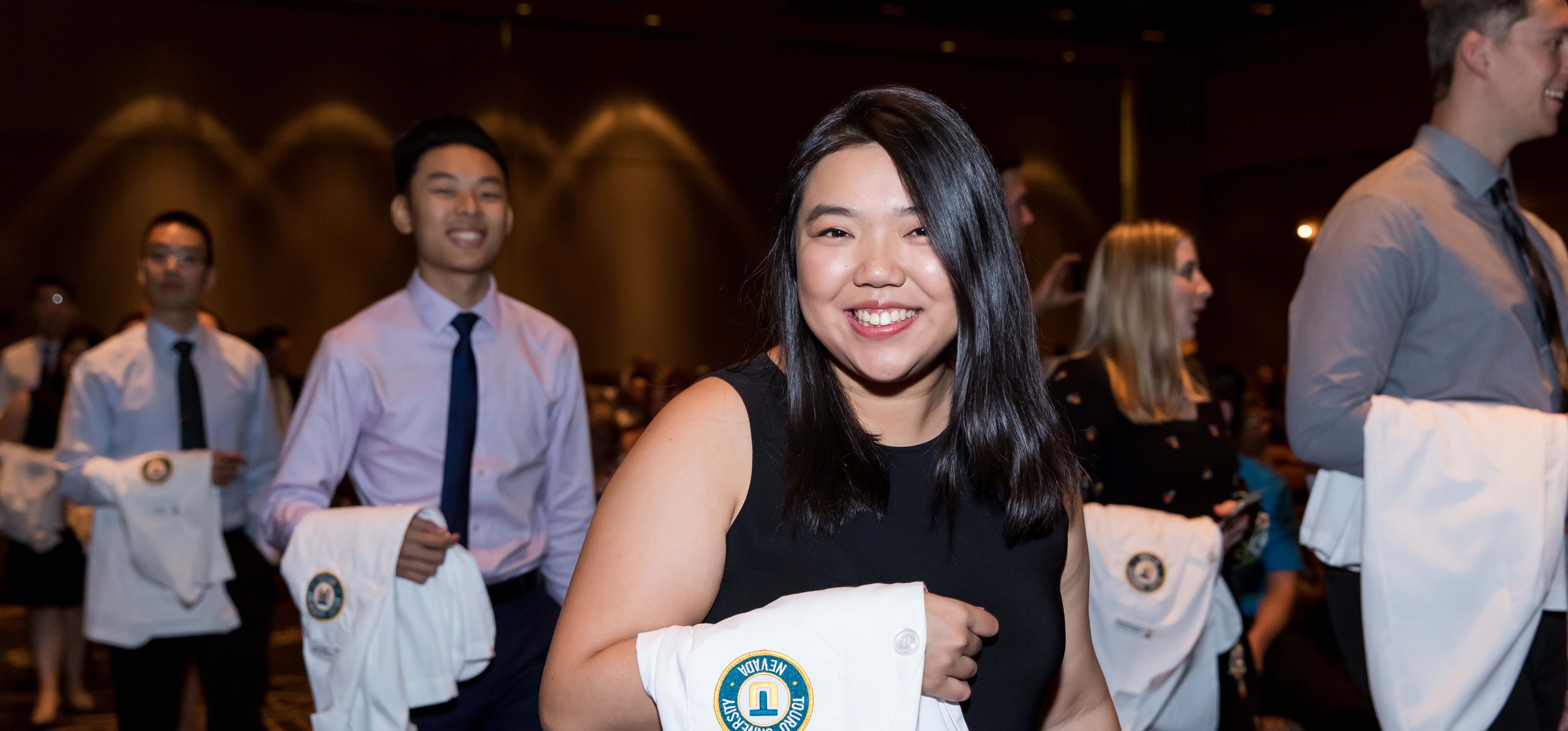 Students walk into the White Coat Ceremony. 