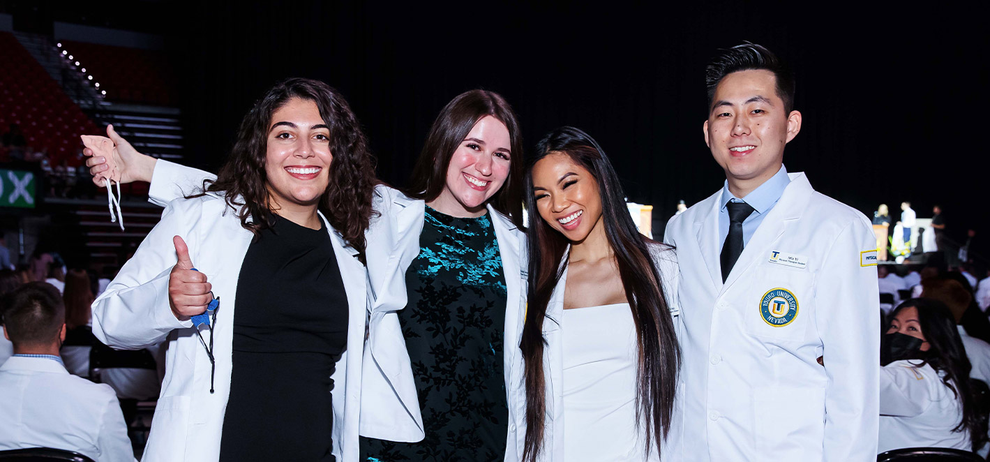 CHHS Students pose in their white coats.