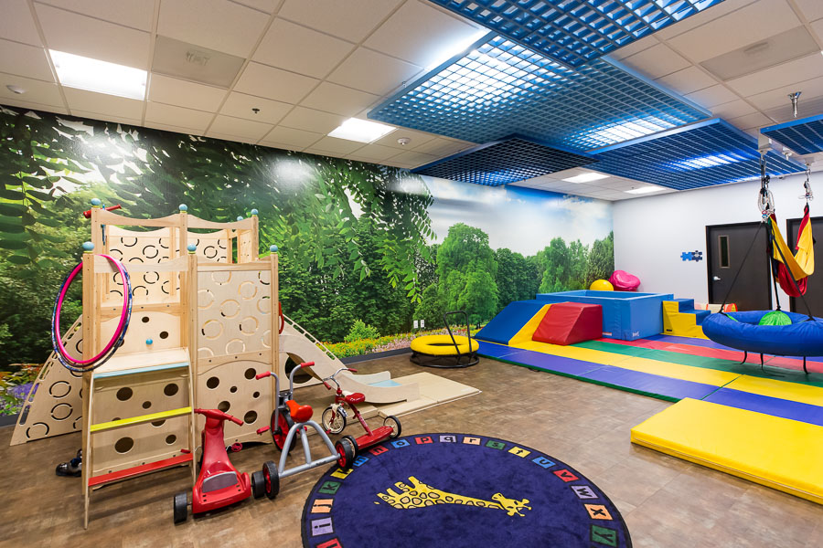 A playroom containing children's gym equipment and toys