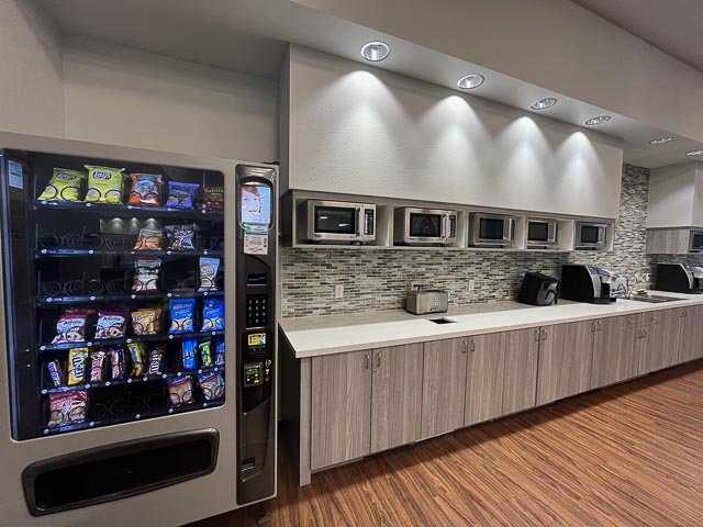 Kitchen prep space with vending machines and microwaves