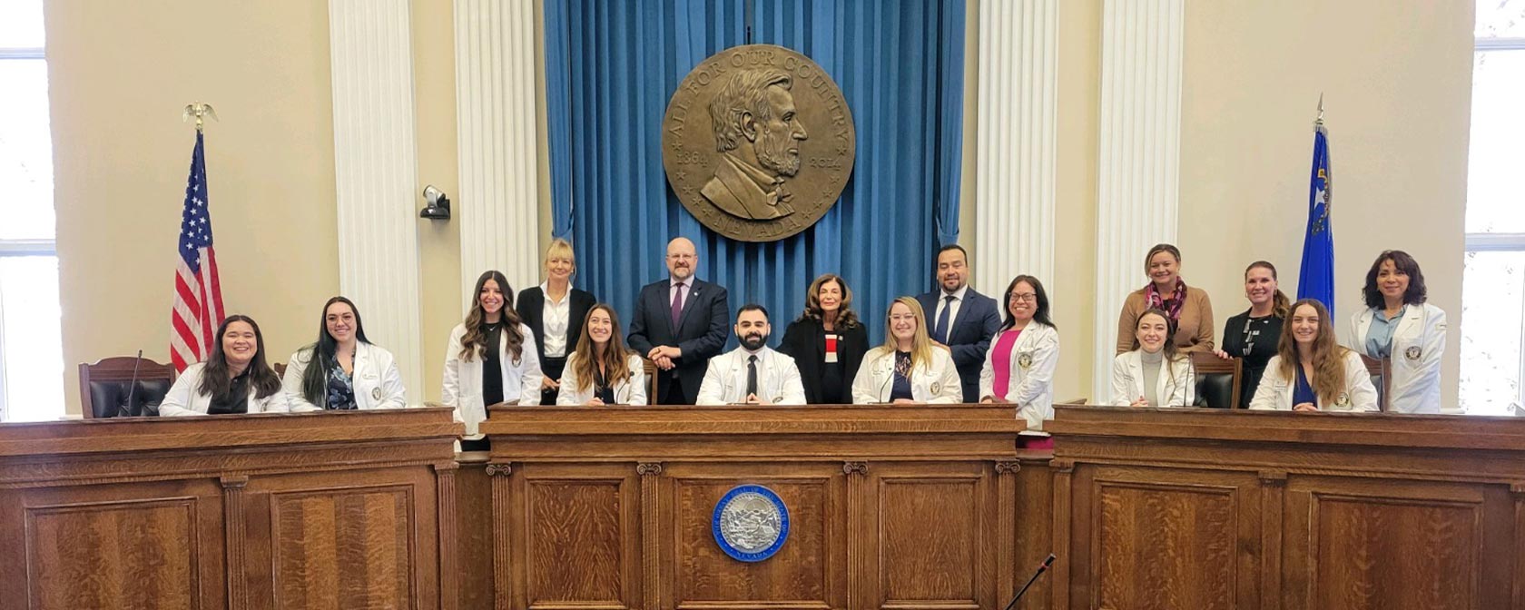 Touro students and representatives gather for a photo inside the Assembly Room at the Nevada State Capitol.