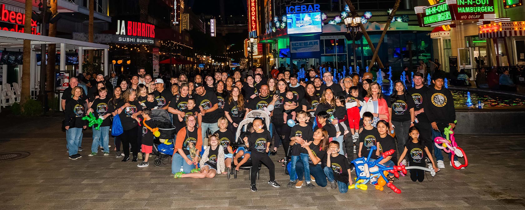 Families from the event gathered on the Linq promenade in front of the High Roller for a group photo.