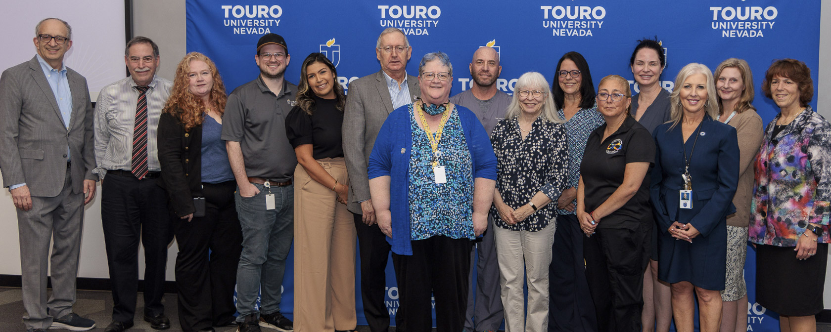 Touro Nevada faculty, staff, and leadership take a group photo during the 2025 employee recognition event.