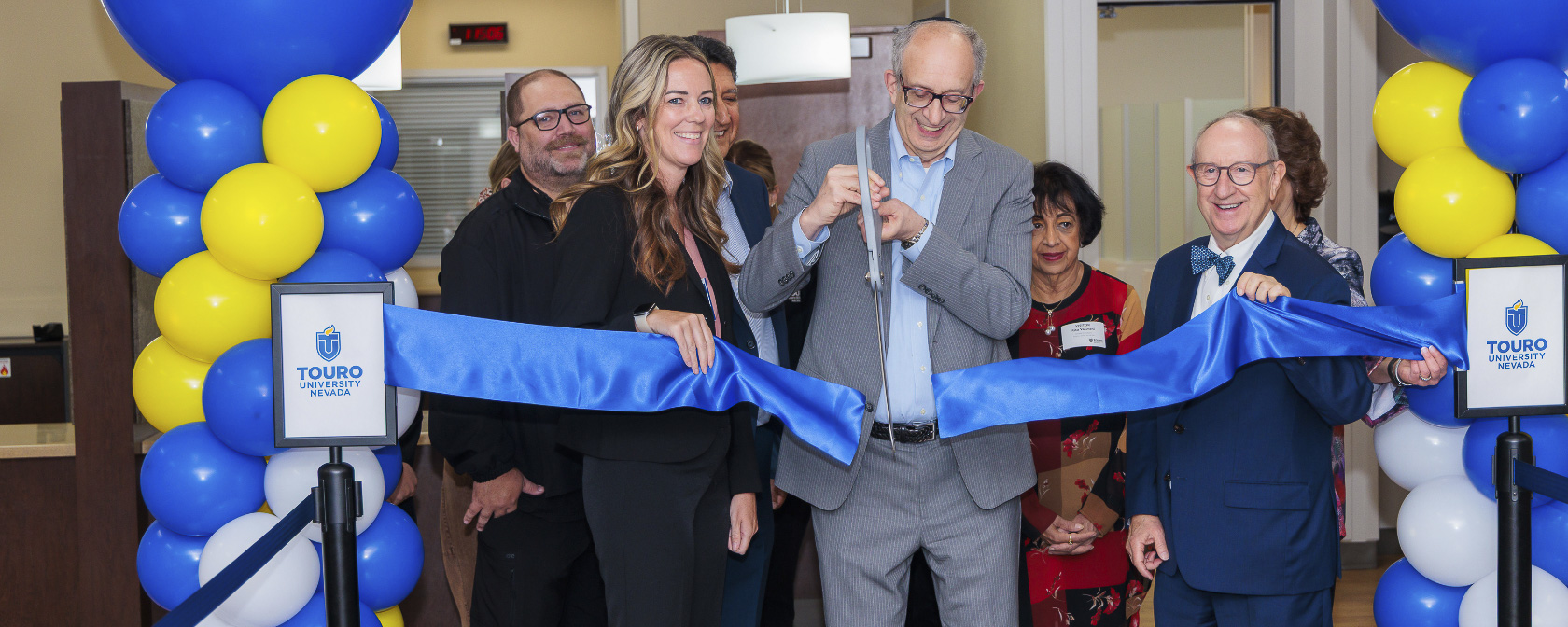 From left to right, Casey Maurice, Dr. Alan Kadish, and Dr. Wolfgang Gilliar cut the ribbon to officially open the new Objective Structured Clinical Examination (OSCE) space at Touro University.