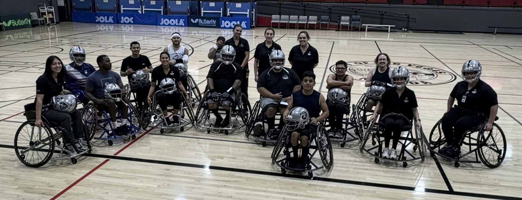 The Raiders Wheelchair Football Team and Touro Nevada Occupational Therapy students on the court.