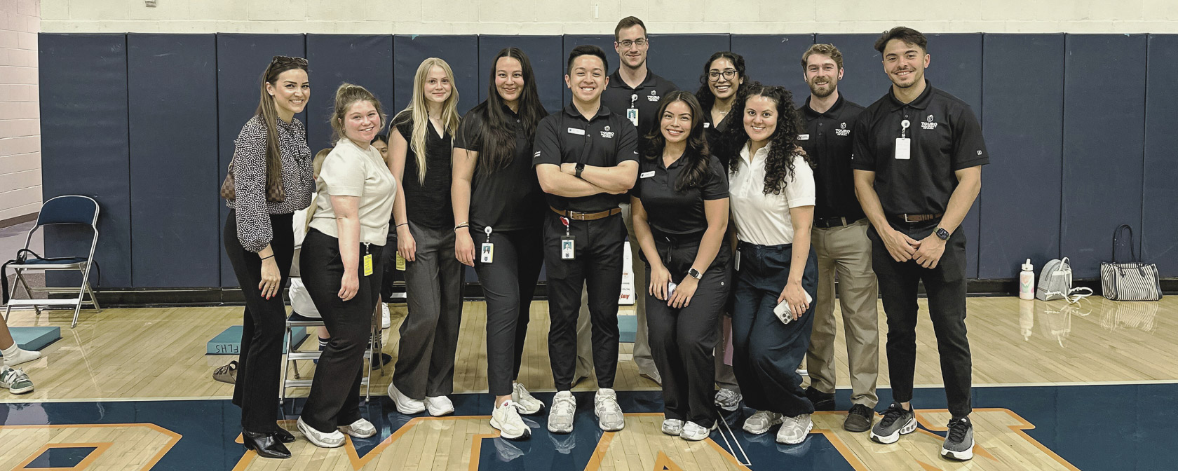 Physical Therapy students take a group photo in the Bishop Gorman High School gymnasium during the concussion screening event.
