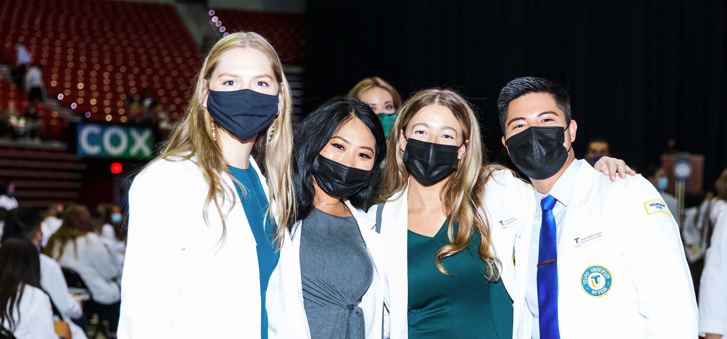 Graduate students receiving their white coats during Touro\'s annual ceremony